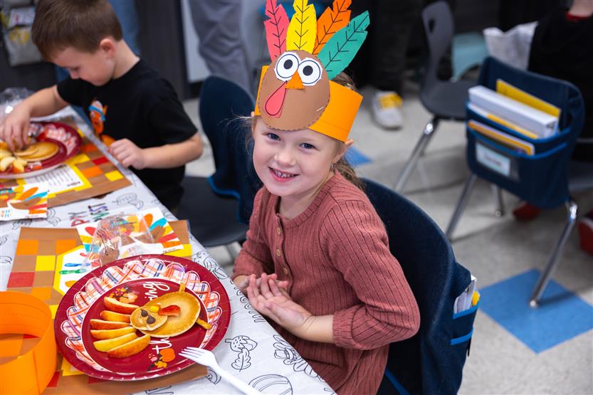 Creekside kindergartners and their families enjoy breakfast